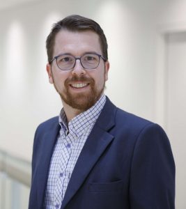 Martin wearing a blue jacket and shirt